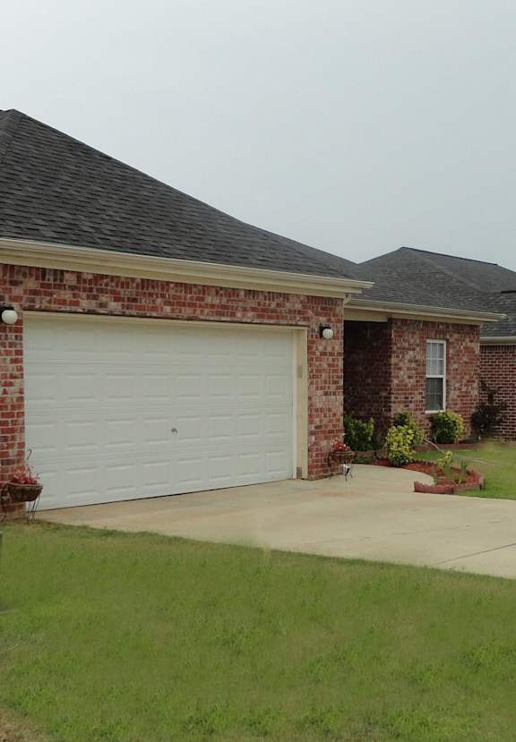 a house with a white garage door in front of it