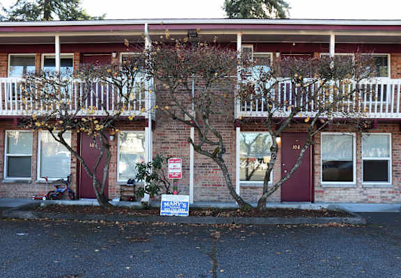 A red building with a sign that says "MARY" in front of it.