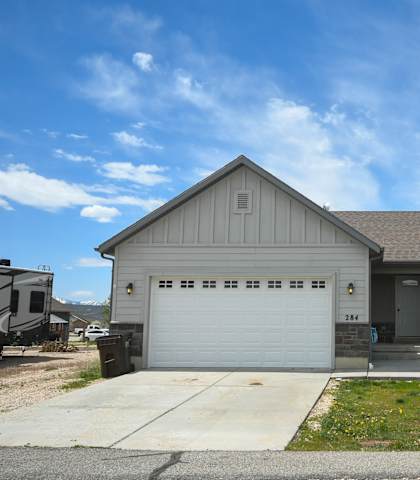a gray house with a white garage door