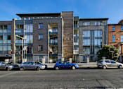 Thumbnail 2 of 5 - a view of a building with cars parked in front of it