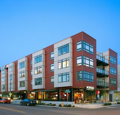 A multi-story building with a red and white facade and the word "FORZA" on the front.