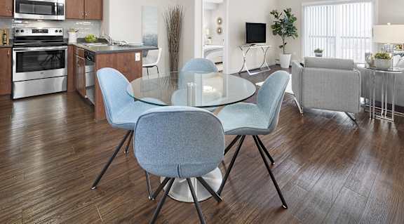A modern kitchen with a dining table and chairs.