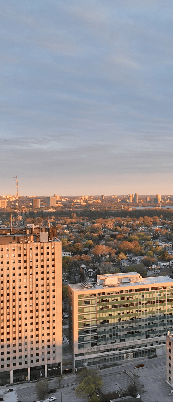 A river flows through a city with buildings on both sides. at Le Columbia Apartments , Quebec, J8Y 0A8