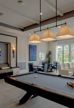 a large living room with a pool table and a large screen tv