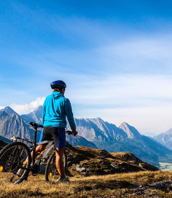 a man standing with his bike on the top of a mountain at The Groves, Gastonia