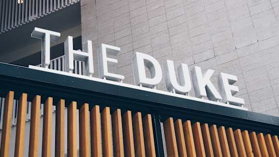The Duke sign is displayed on a building.