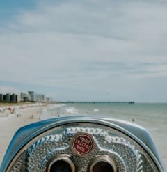 a view of the beach from a coin operated binoculars