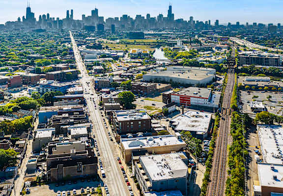 A cityscape with a highway running through the middle of a residential area.