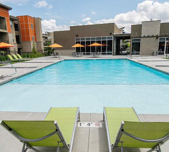 Relaxing Swimming Pool with Lounge Chairs at Lofts at 7800 Apartments, Midvale, Utah