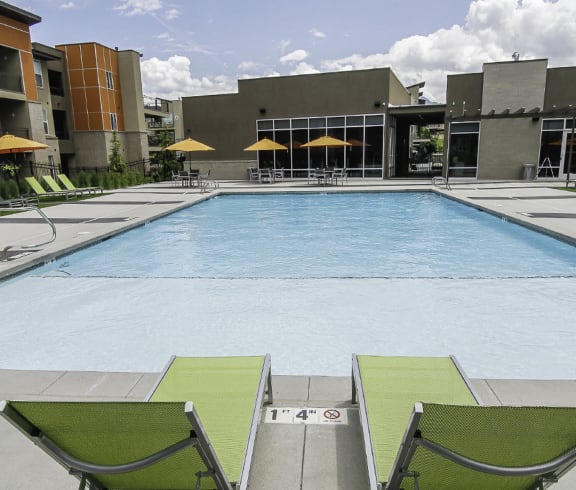 Relaxing Swimming Pool with Lounge Chairs at Lofts at 7800 Apartments, Midvale, Utah