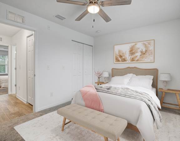 The Marley at Trout River Apartments in Jacksonville, FL 32218 a bedroom with a bed and a ceiling fan