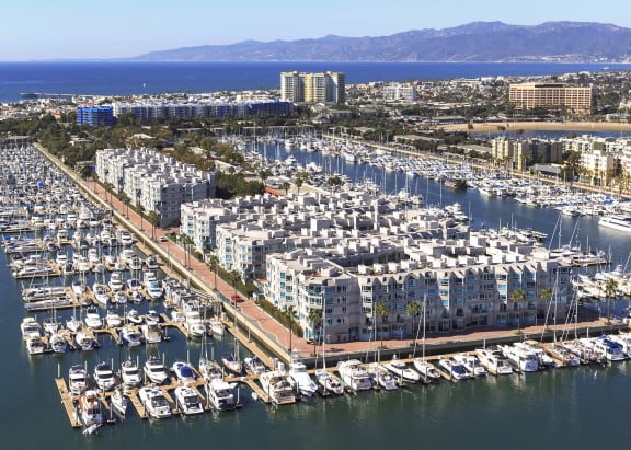 an aerial view of a marina filled with boats