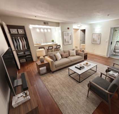 A living room with a couch, chairs, and a television.