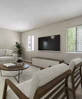 A living room with a couch, chair, and television.