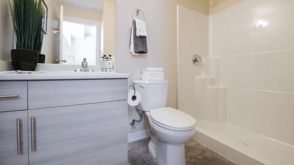 a bathroom with a toilet and a sink and a shower
