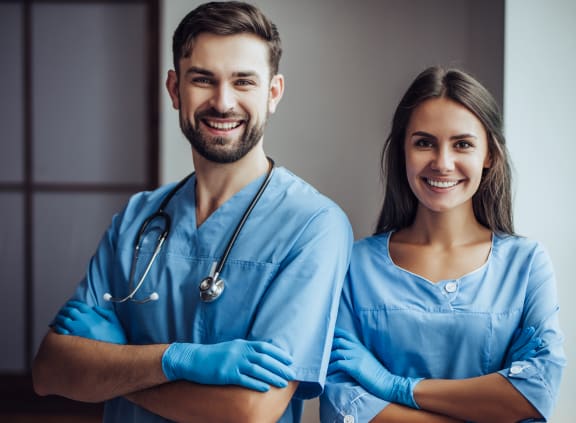 portrait of a young couple of doctors in blue scrubs