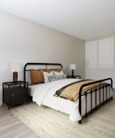 A bedroom with a large bed and a nightstand.