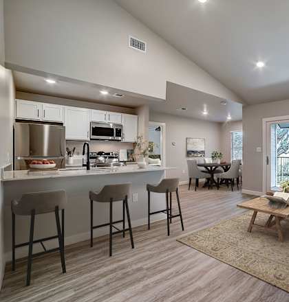 an open floor plan with a kitchen and a living room