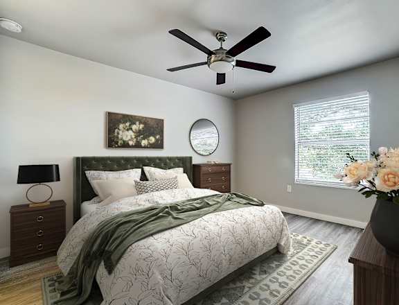 a bedroom with a large bed and a ceiling fan  at The Frederick, San Antonio