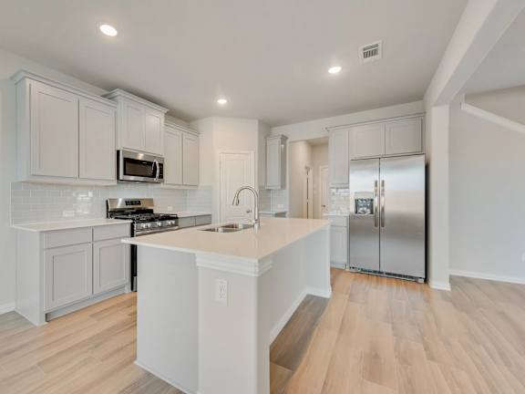 A Kitchen With White Cabinets at Cottages at Beltmill Apartments, Texas