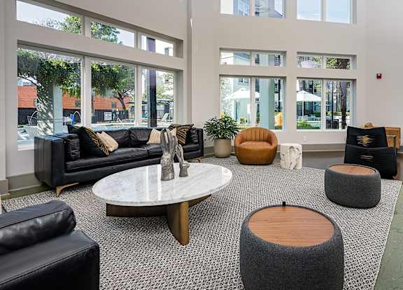 Lobby with seating and tables and lots of windows at Trend Design District, Dallas, TX