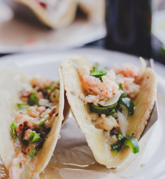 two tacos cut in half on a plate