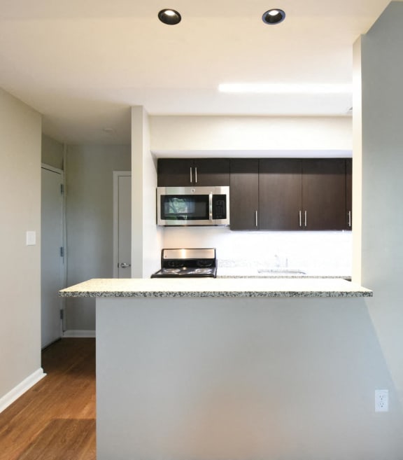 a kitchen with a counter top and a stove top oven