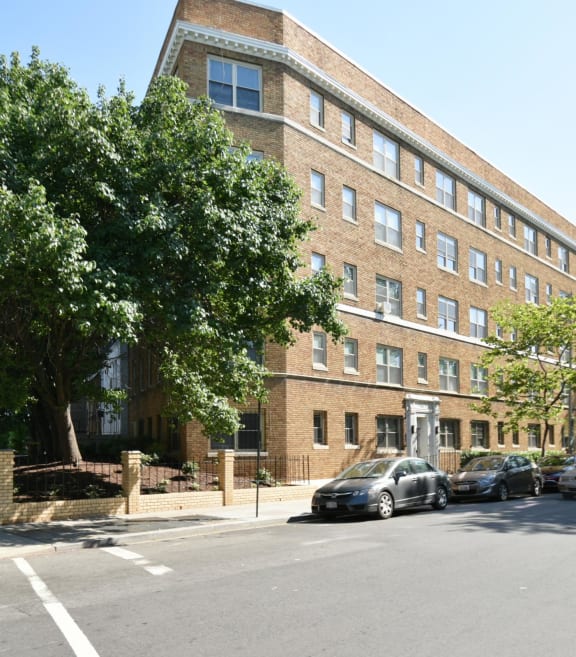 a large brick building with cars parked in front of it