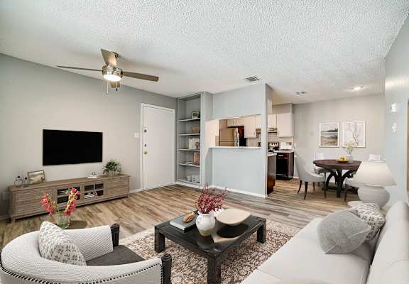our apartments offer a living room with a couch a coffee table and a flat screen tv