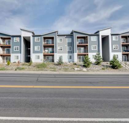 Apartment building with grey and blue exterior.
