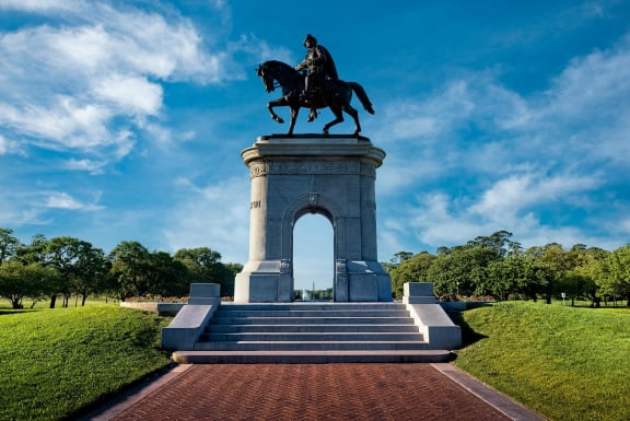 a statue of a man on a horse in a park