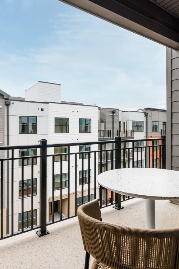 a patio with a table and chairs on a balcony