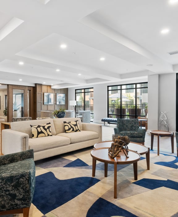 a living room with a couch and chairs and a table