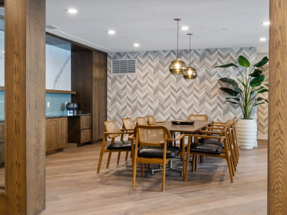 a dining room with a wooden table and chairs