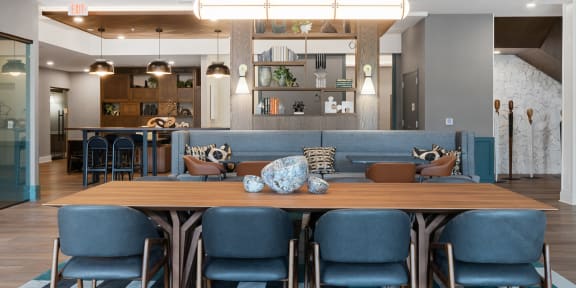 a dining room with blue chairs and a wooden table