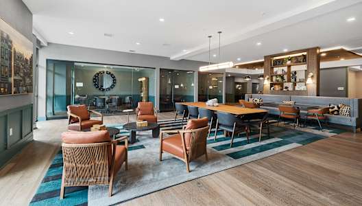 a lounge area with chairs and tables and a pool table