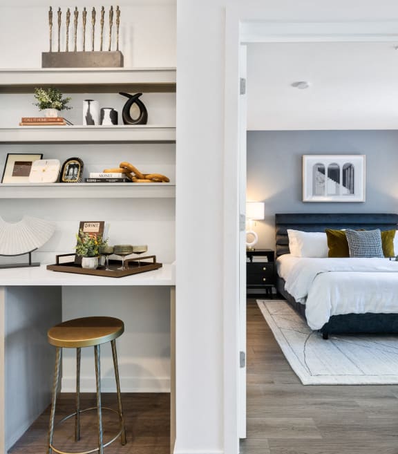 a bedroom with a bed and shelves and a stool at Stonehill at West Orange, West Orange, New Jersey
