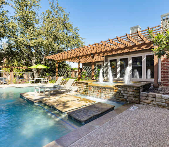 a backyard with a pool and a patio with chairs and a pergola