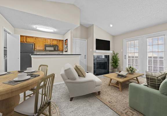 a living room with a couch a chair a table and a fireplace