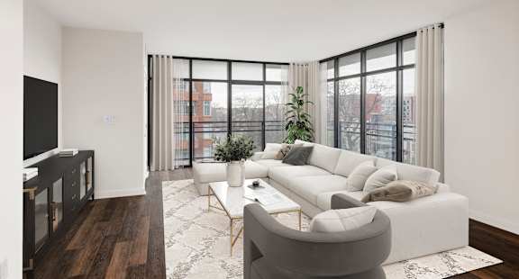 A living room with a white couch and a television. at Loree Grand at Union Place, Washington, 20002
