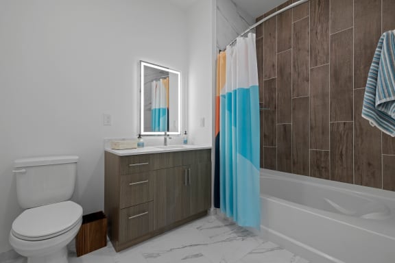 a bathroom with a toilet sink and tub and a shower