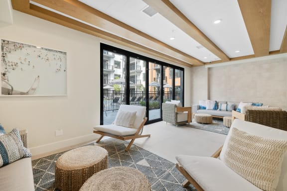 a living room with couches and chairs and a balcony