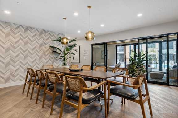 A dining room with a wooden table and chairs.