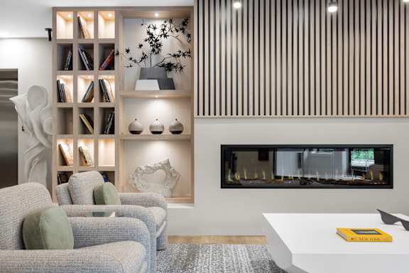 Living room with a fireplace and a bookshelf1 at The Lawrence, Parsippany, NJ, 07054