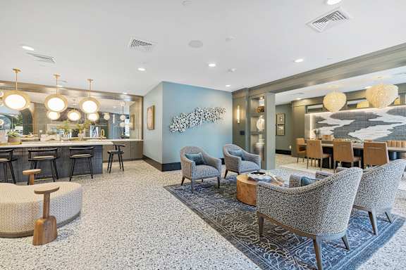 A spacious room with a dining table and chairs.