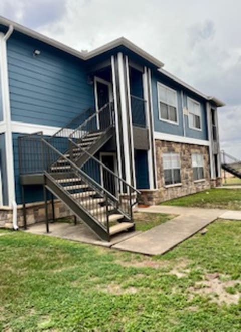 a blue house with stairs in front of it