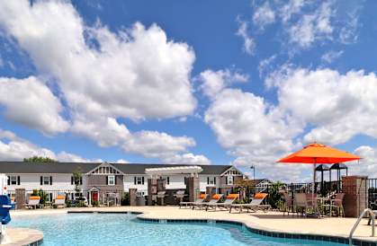 A pool with a sign offering a 1 month free with 13 month lease.