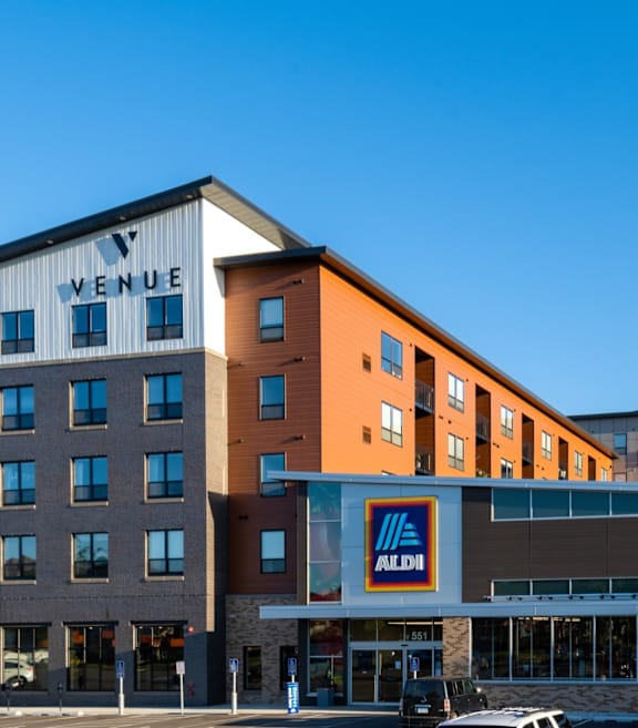 a large hotel building with cars parked in front of it