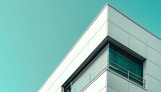 A modern building with a large window and a triangular design on the top.