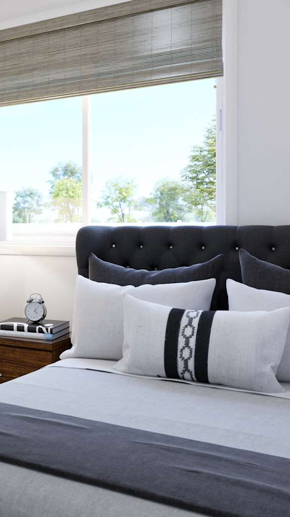A bedroom with a large bed and a painting on the wall.